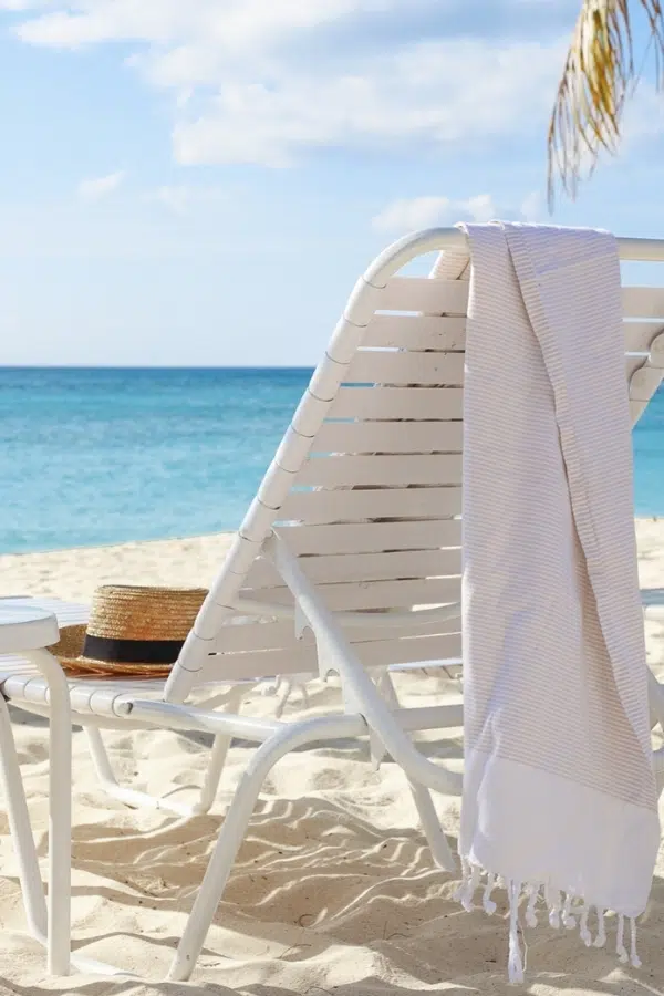 Plantana Cayman Islands Seven Mile Beach Vacation Rental - Homepage - Stay Once Return Forever - Beach Chair with Hat and Towel